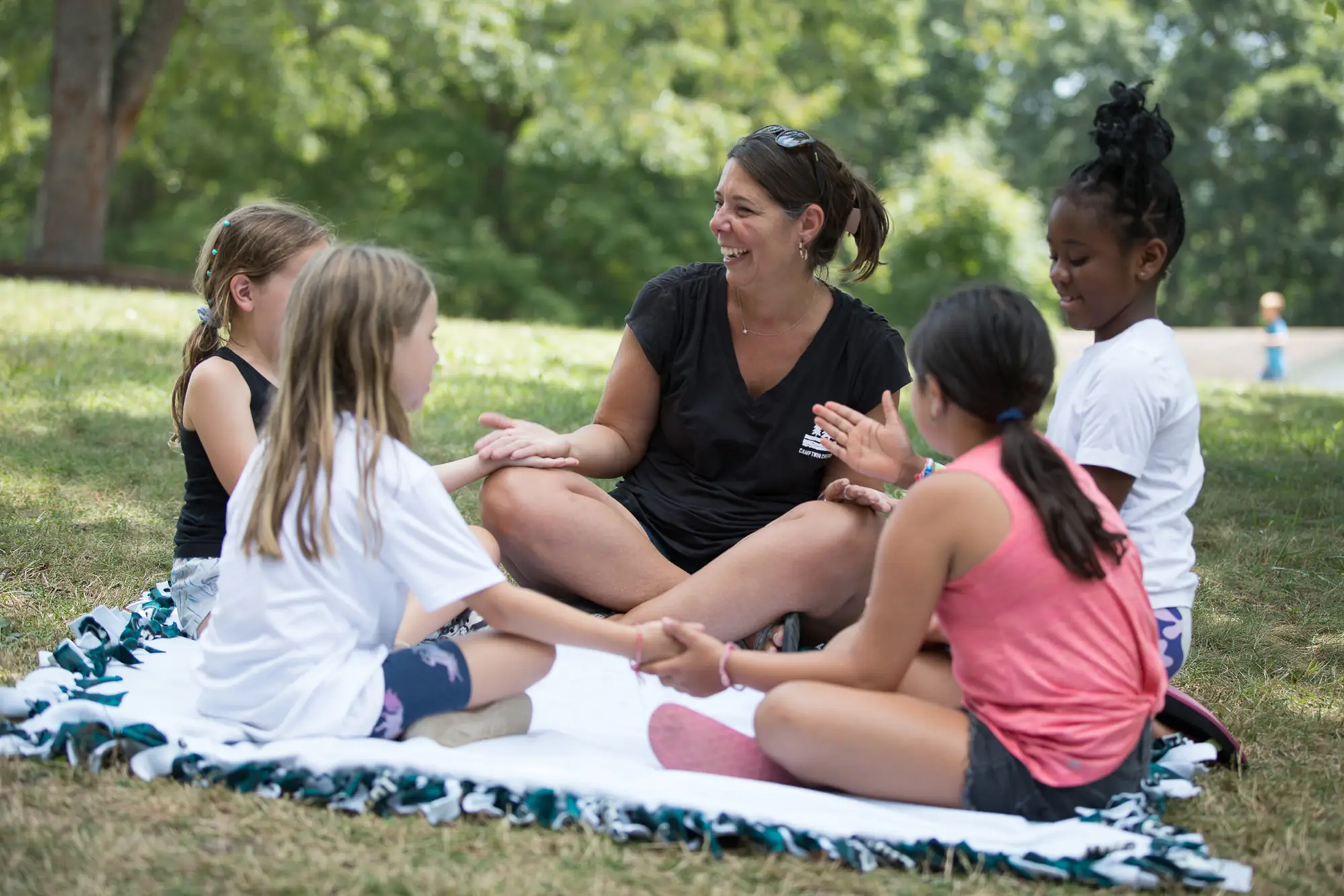 Camp Twin Creeks Director Amy talks to a group of young campers