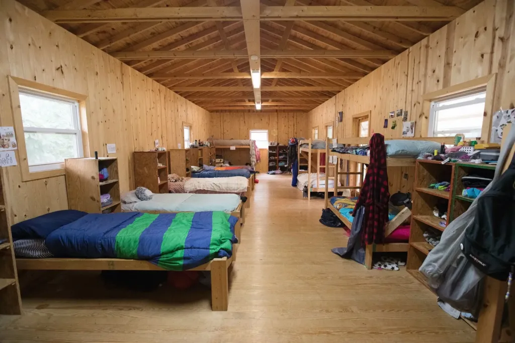 Bunks line the walls inside a cabin at Camp Twin Creeks