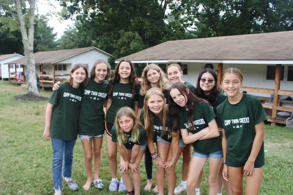 A group of camp twin creek campers smile and pose for a photo