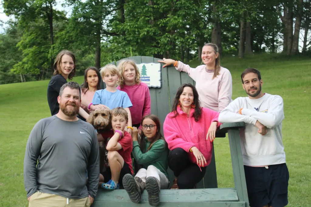 A family sits on the oversized Adirondack chair