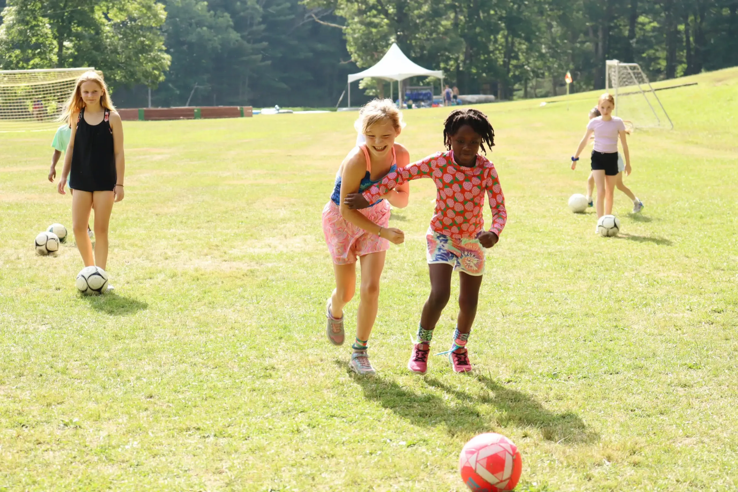 Two Young Campers Play Soccer