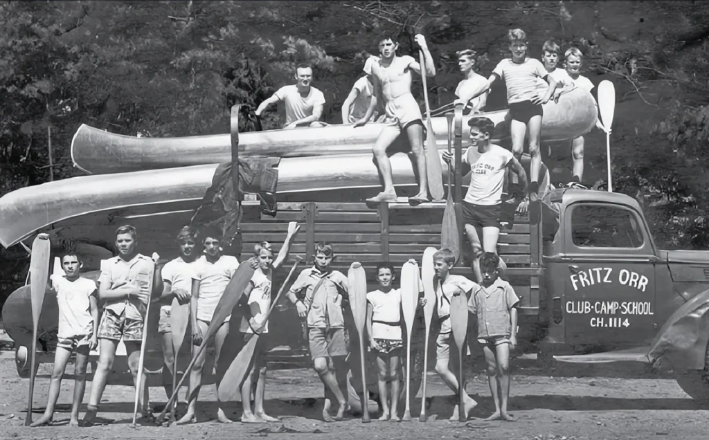 Camp Twin Creeks history: campers standing by truck