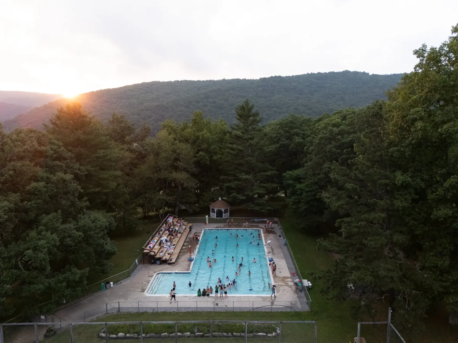 Aerial view of the swimming pool and mountains at Camp Twin Creeks, a sleepaway summer camp for kids and teens in West Virginia